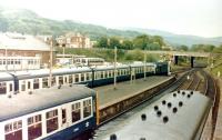 A special about to depart from Largs in 1984, thought to be a day excursion from Barrow in Furness. A well-filled station with the goods yard infested by buses.<br><br>[Colin Miller //1984]