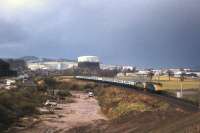 With two Class 26s in charge, a southbound train heads away from Millburn Junction in the 1970s and is about to pass signs of the new A9 construction works.<br><br>[Frank Spaven Collection (Courtesy David Spaven) //]