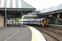 An Edinburgh - Dundee train arrives at Perth platform 2 on 15 June 2006, while in the background an Inverness - Glasgow Queen Street service is leaving platform 4.  <br><br>[John Furnevel 15/06/2006]