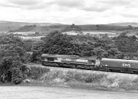 66142 heading what is thought to be the 11.23 coal empties from Milford West Sidings to New Cumnock, seen here just north of Armathwaite on 26th June 2013.<br><br>[Bill Jamieson 26/06/2013]