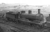 Withdrawn Caley <I>Jumbo</I> 57353 stored awaiting disposal on the scrap road at Hurlford shed, Kilmarnock, on 17 April 1962. The 1894 veteran was eventually cut up at Connels of Coatbridge in June the following year. <br><br>[David Stewart 17/04/1962]