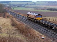 DBS 66065 stands at Forthar, between the former stations at Falkland Road (in the background) and Kingskettle on 5 December 2013. The locomotive is at the head of a train of track panels from a relaying programme at Ladybank. The short-lived Forthar Lime Works branch trailed in from the left.<br><br>[Bill Roberton 05/12/2013]