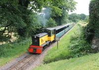 R&ER diesel <I>Perkins</I> lifts a train for Dalegarth up the last few yards of incline before the level crossing at The Green station. View towards Ravenglass in July 2013. <br><br>[Mark Bartlett 27/07/2013]