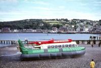 A Clyde Hover Ferries hovercraft on the beach at Rothesay in August 1965. More traditional modes of transport are represented by <I>Cowal, Loch Fyne</I> and <I>Talisman</I> in the background.<br><br>[G W Robin 23/08/1965]