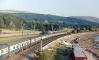 A Largs to Macclesfield excursion skirts the shoreline as it leaves Largs on 19 August 1984 [see image 23189]. This scene is now much changed with the track singled and electrified and a large marina to the right.<br><br>[Colin Miller 19/08/1984]