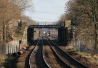 DMU 158738 on a Whifflet - Glasgow Central service boarding at Baillieston station on 9 January 2014. View east from the platform at Mount Vernon. Note the efforts of local graffiti artists on the disused bridge near the former greyhound race track.<br><br>[Colin McDonald 08/01/2014]