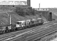 The last in a procession of Engineer's trains to pass Goose Hill Junction northbound on Saturday 12th February 1977 was a ramshackle collection of high and low sided open spoil wagons hauled by 37098.  Note the photographers waiting on Newstead Lane Bridge for the passage of the <I>Western Finale</I> railtour which had been due almost an hour previously. [See image 38590]<br><br>[Bill Jamieson 12/02/1977]