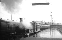 A wet day at Inverness station on 24 August 1965 sees ex-Highland Railway Jones Goods no 103 carrying out manoeuvres. The locomotive was involved in the operation of special trains being run at that time in connection with the Highland Railway centenary celebrations.<br><br>[K A Gray 24/08/1965]