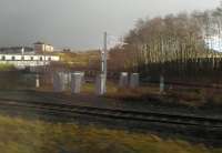 Grab shot from a passing train on 11 January 2014 showing the electrification masts which are now advancing along the Cowlairs Chord and also the Springburn-Eastfield side of the triangle.<br><br>[John Yellowlees 11/01/2014]