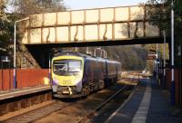 A TransPennine service to Manchester Airport calls at Lostock station on 22 October 2011. Immediately beyond the platforms is the junction with the line from Wigan via Westhoughton joining from the right. [See image 29542] for the view towards the station from the junction.<br><br>[John McIntyre 22/10/2011]