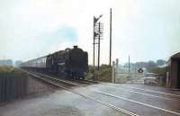 72007 <I>Clan McIntosh</I> about to take the morning Crewe - Perth train over Lenziemill level crossing, south west of Cumbernauld, in August 1965.<br><br>[G W Robin 03/08/1965]