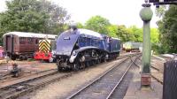 No. 7 <I>Sir Nigel Gresley</I> shuffles out of Pickering station on 1 October 2009 to run round its train... admired by one or two lesser items of motive power.<br><br>[Colin Miller 01/10/2009]