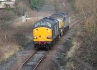 DRS 37609 accelerates towards Heysham after the reversal at Morecambe with a single flask wagon and 57008 in tow. This view taken from the Regent Rd bridge in Morecambe on 15 January. The <I>As Required</I> flask train runs in the afternoon after the daily boat train has cleared the section at Bare Lane.  <br><br>[Mark Bartlett 15/01/2014]