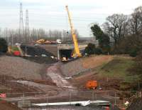 Looking along the Borders Railway route north towards the breached section of the Edinburgh City Bypass at Sheriffhall on 17 January 2014, with the high capacity crane now back on site.<br><br>[John Furnevel 17/01/2014]