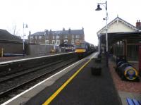 The 10.43 departure for Glasgow Queen Street pulls into Broughty Ferry, Scotland's oldest operational station, on Friday 17 January. Note the barrel-train planter adopted by the local Rotary, standing on the right.<br><br>[John Yellowlees 17/01/2014]