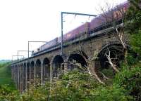 An up EWS coal train crossing the viaduct over the River Aln, just north of Alnmouth station, in May 2004. The listed structure (also referred to as Lesbury Viaduct) was built by Robert Stephenson in 1848/9.<br><br>[John Furnevel 24/05/2004]