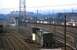 Long lens view from Storrs Hill Road bridge over the east end of Healey Mills Yard on a Sunday in April 1974. The depot has a good selection of locos on shed with class 40s predominating but examples of classes 08, 31 and 37 also visible. The ex-B1(?) tender was a fixture in the foreground siding for many years. <br><br>[Bill Jamieson /04/1974]