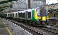 A London Midland class 350 EMU on hire to TransPennine Express for driver training departs the middle road at Carlisle on 17 October 2013 on its way back to Preston.<br><br>[Ken Browne 17/10/2013]