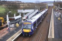 170472 calls at Rosyth with an Edinburgh-bound service on 19 January with construction work on a new footbridge in evidence and the temporary structure in the background.<br><br>[Bill Roberton 19/01/2014]