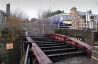 Kirkcaldy Harbour branch bridge over Dunnikier Road is currently in course of demolition.  Seen here on 18 January 2014 with the deck already gone as a class 170 speeds past with a Fife Circle service.<br><br>[Bill Roberton 18/01/2014]