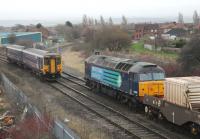 The points have been changed and DRS 57003 is just about to set off along the Heysham Branch on 8 January as 156454 passes on a Morecambe to Lancaster service. Moments later the junction disappeared from view briefly when a cloud of blue smoke erupted from the Class 57 as it moved off. <br><br>[Mark Bartlett 08/01/2014]