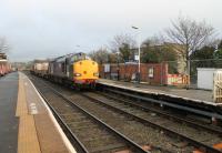 Another piece of railway history gone. The signal box at Bare Lane was demolished in January 2014, over twelve months after closure.  Trains for Heysham no longer stop to collect a staff and 37038 and 37611 take two flasks past the site of the box without stopping on 22 January 2014. [See image 37896] for the same location in 2012.<br><br>[Mark Bartlett 22/01/2014]