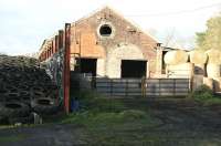 <I>'Sub to Blaydon (52C)'</I> was how the old 2-road Border Counties locomotive shed at Reedsmouth was described at the time of its official closure in September 1952. The modifield building is seen here in use by the local farmer in 2007, with rails still in place. View is north with Reedsmouth station behind the camera.<br><br>[John Furnevel 05/11/2007]