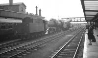 A trio of Doncaster shed's WD Austerity 2-8-0s clanking through the centre road at Doncaster station in September 1962. Thee trio comprises 90235, 90144 and 90551.<br><br>[K A Gray 08/09/1962]