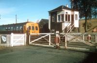 An Edinburgh - Gorebridge local dmu photographed on the level crossing at Heriot in September 1968. The train has run ecs from Gorebridge in order to reverse on the crossover here.  (Heriot was used as the crossover point following closure of the facility at Borthwick Bank two months earlier). [See image 24002]<br><br>[Bruce McCartney /09/1968]