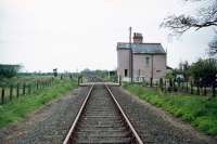 Looking west over Belaugh Green level crossing on 2nd May 1976. Situated on the line between Wroxham and Coltishall, it was then in occasional use for freight from Lenwade via the Themelthorpe curve. A level crossing still exists here for the narrow gauge Bure Valley Railway which now uses the trackbed.<br><br>[Mark Dufton 02/05/1976]