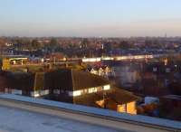 The rising sun reflects off the leading car as a Heathrow-bound Piccadilly line service is seen at Hounslow Central through a hotel corridor window on 14 January.<br><br>[Ken Strachan 14/01/2014]