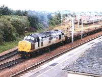 Transrail liveried 37221 attaching wagons to an engineers train in the sidings on the north side of Carstairs station in the summer of 1997.<br><br>[John Furnevel 04/07/1997]