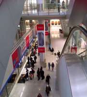 Looking down into the bowels of Hong Kong airport towards the underground railway linking terminals 1 and 2. Passengers are waiting alongside the platform screen doors on the lower left as a train arrives.<br><br>[Ken Strachan 23/01/2014]