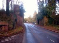 Scene just East of the station site at Newent, Gloucestershire, where these stone abutments alongside the B4215 still look substantial some 50 years after the closure. The small brick store just visible on the left of the picture looks intriguing.<br><br>[Ken Strachan 29/12/2013]