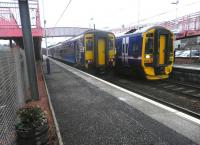 156439 has recently arrived at Whifflet platform 2 on 30 January with a train from Glasgow Central. Meantime 158739 pulls into platform 1 with a Motherwell-Cumbernauld service.<br><br>[John Yellowlees 30/01/2014]