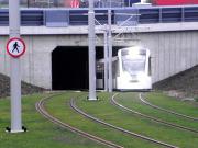 An eastbound tram emerging from the A8 underpass on the approach to Gyle Centre on 30 January. <br><br>[Alasdair Taylor 30/01/2014]
