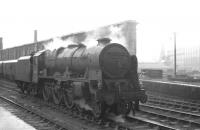 Royal Scot 46128 <I>The Lovat Scouts</I> stands in the rain on the west side of Carlisle station on 17 August 1963 awaiting the arrival of the 10.35am Blackpool - Perth / Edinburgh Princes Street which it will take forward [see image 37728].<br><br>[K A Gray 17/08/1963]