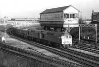 Mid-afternoon on 29th January 1977 sees a pair of BR Sulzer Type 2s, 25190 and 25153, bring a long block train comprised mainly of Presflos past Chester No. 6 box at the western end of the triangle to the west of the station. Presumably the train is bound for Penyffordd cement works (but any information to the contrary would be welcome).<br><br>[Bill Jamieson 29/01/1977]