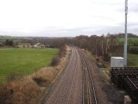 View north towards the former Crigglestone Junction, from the over-bridge by the site of Crigglestone West station on 5 February 2014. Note the long welded down line on steel sleepers laid over the previous night to replace well worn jointed track on wooden sleepers. Cut sections of the old track are stacked alongside the up line which is also due to be replaced.  <br><br>[David Pesterfield 05/02/2014]