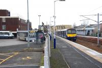 The convenient train / bus interchange at Lanark, with direct access available between platform and bus terminus. Photographed on  30 January 2014, with the 12.53 train to Milngavie preparing to leave the platform and the 12.17 bus ex-Lesmahagow having recently arrived alongside.<br><br>[John Furnevel 30/01/2014]