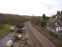 View south over the former Crigglestone West station site on 5 February, showing the new long welded down line on steel sleepers [see image 46201]. The former station masters house and staff cottages, still occupied and in everyday use, are to the right. The exchange sidings with Crigglestone Colliery, sited alongside and also connected to the east - west Thornhill to Notton Junction line, were to the left of the present running lines. <br><br>[David Pesterfield 05/02/2014]