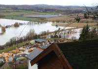 The long-abandoned trackbed of the Ross to Monmouth branch still keeping its head above water. Walford Halt was just off to the right. The bright green bank nearer the camera is a bund to protect the sawmill.<br>
<br><br>[John Thorn 11/02/2014]