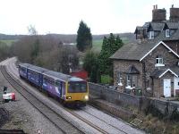 A Northern Rail three car class 144 runs past the former Crigglestone West station along the newly laid down line on 6 February 2014. The initial re-laid section of the up line, from the curve towards Woolley tunnel, can be seen in the distance.<br><br>[David Pesterfield 06/02/2014]