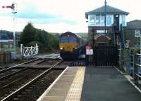 Coal empties heading east towards Newcastle about to run over the level crossing at Haydon Bridge in fading light on a September evening in 2003.<br><br>[John Furnevel 22/09/2003]