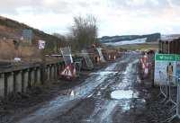 Looking south from Heriot level crossing on 11 February.  The old up platform has been breached in a couple of places.  In the distance is the square frame of a new road bridge.<br><br>[Bill Roberton 11/02/2014]