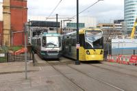 Extensive rebuilding at Manchester Victoria will see it close to trams for nine months from February 2014. The famous <I>Hole in the Wall</I> has already gone as seen here. One of the very few operational early series trams, 2001, passes 3056 near the station entrance four days before the station tram stop closed. Trams will continue to pass through while work takes place but passengers will have to use Shudehill. [See image 33280] for the same location prior to the rebuilding work. <br><br>[Mark Bartlett 13/02/2014]