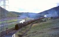 Britannia Pacific 70037 <I>Hereward the Wake</I> climbing just north of Greskine on 31 July 1965. Working hard on the rear of the train is Beattock banker 42694.  <br><br>[John Robin 31/07/1965]