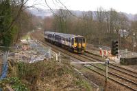 A Manchester bound service heads west from Todmorden on 10 February 2014. The  work going on here is associated with the construction of a footbridge to replace the foot crossing. The signal on the right shows that this is an outpost controlled from Preston PSB.<br><br>[John McIntyre 10/02/2014]