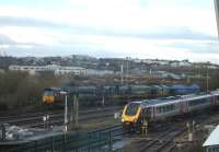 A CrossCountry Voyager runs into Bristol Parkway station, to form the 10.09 service to Manchester, as a trio of mixed livery Freightliner operated class 66 locomotives moves onto a stabling siding in an unusually empty yard. Leading is DRS liveried 66415, then Freightliner liveried 66956, with Bardon Aggregate liveried 66623 at the rear.  <br><br>[David Pesterfield 13/02/2014]