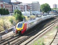 The 14.22 Brighton - Manchester Piccadilly Virgin Voyager crosses onto the platform 2 loop at Kensington Olympia as it slows to make its scheduled stop on 23 July 2005. Bay platform 1, on the far left, is used by District line services.<br><br>[John Furnevel 23/07/2005]